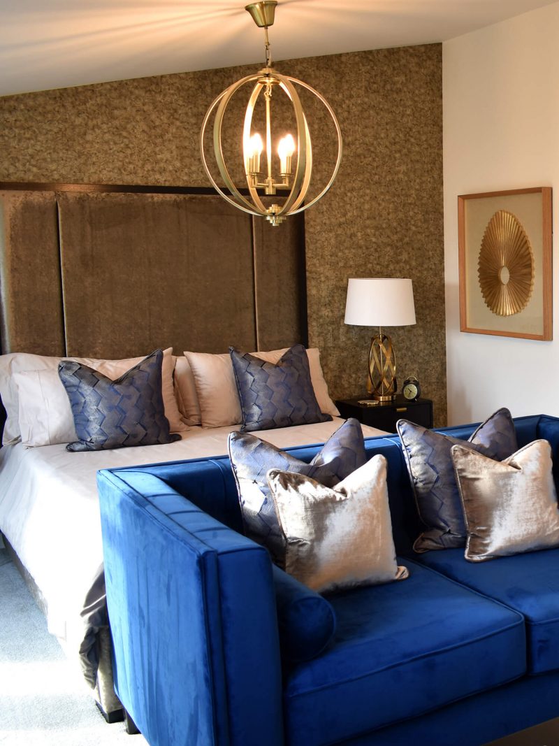 Master-Bed-2 Master bedroom with gold lamp and purple couch
